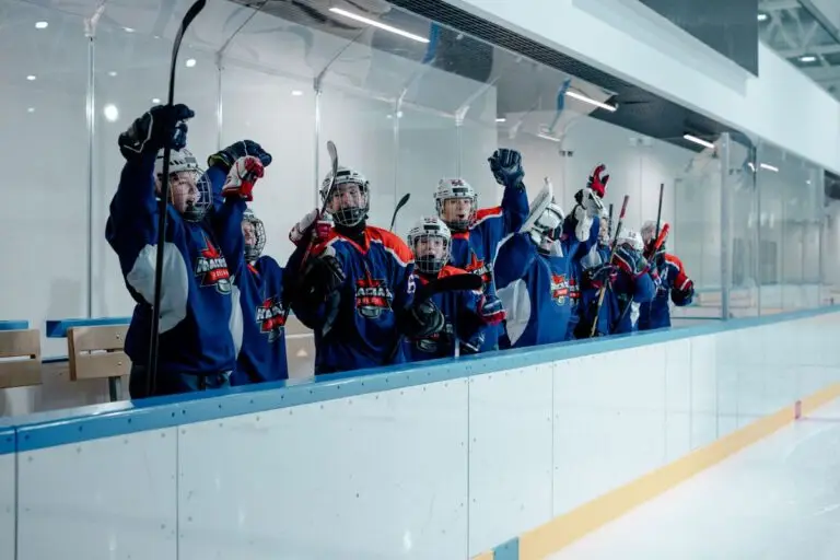 Young hockey players gathered at the edge of the rink